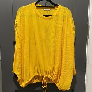 Yellow flowy blouse with tightened bottom